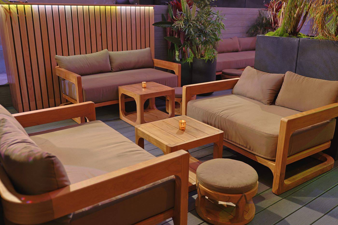 Teak sofas and tables in the rooftop garden